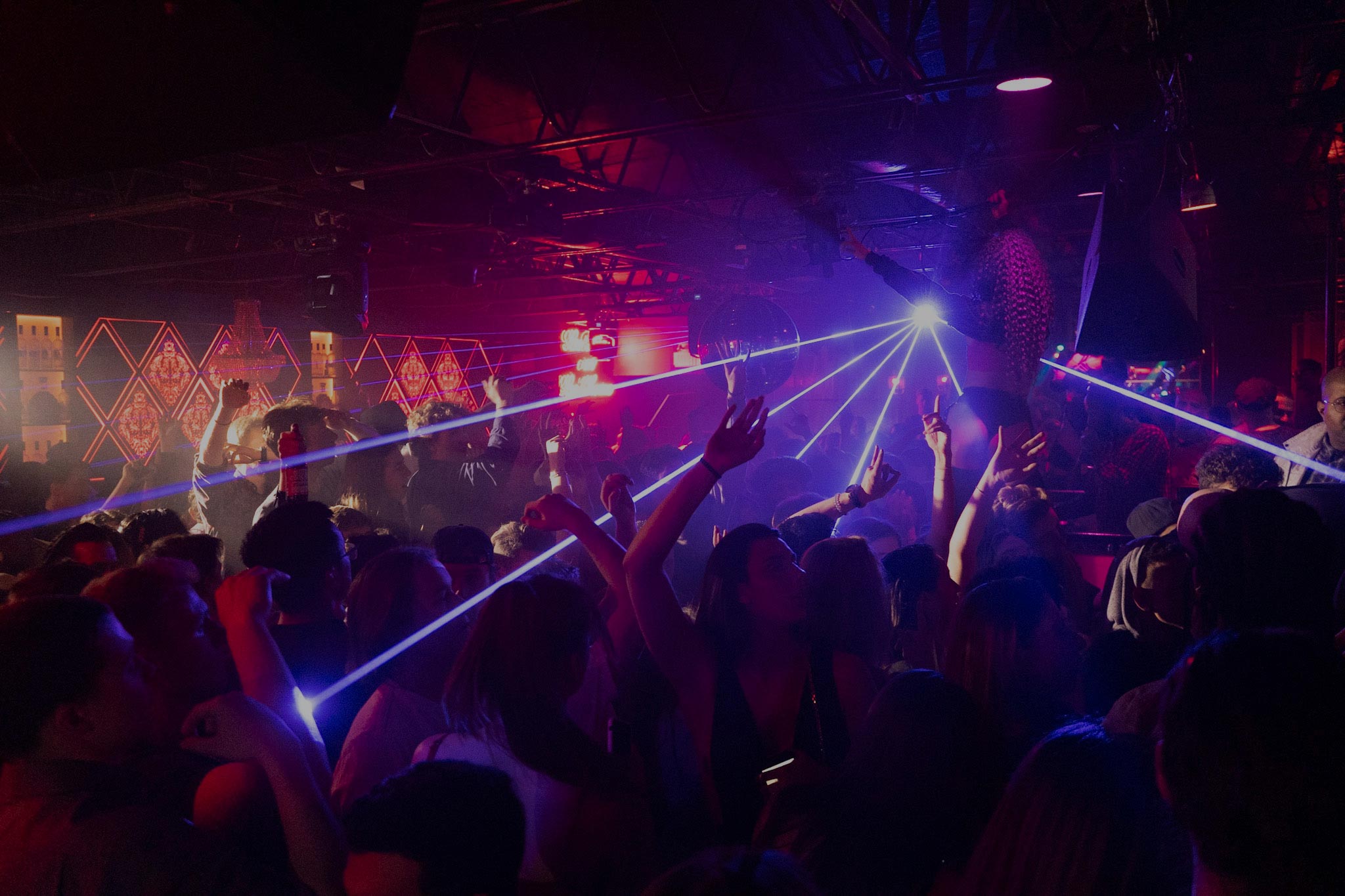 People dancing and listening to music in nightclub