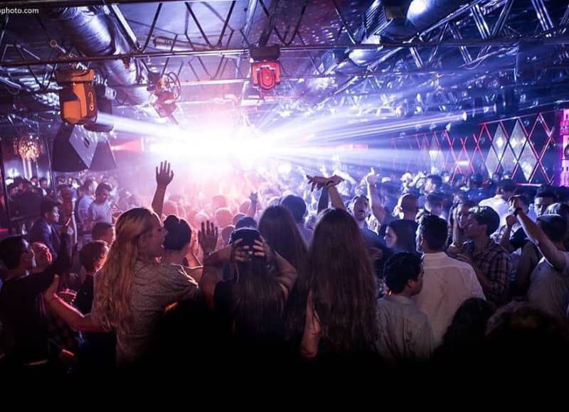 People partying at a show in a nightclub